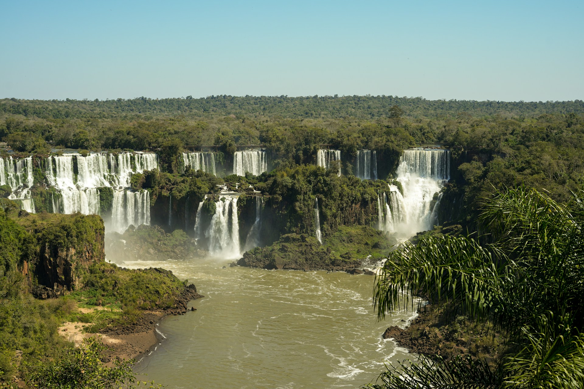 Wide panorama of Iguaçu Falls and surrounding rainforest