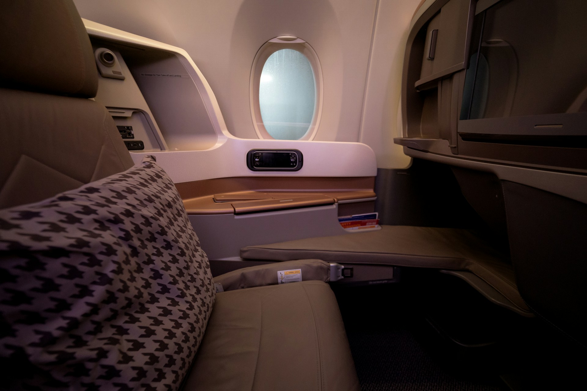 a business class cabin seat, empty and inviting, soft cabin lighting a business class cabin seat, empty and inviting, soft cabin lighting