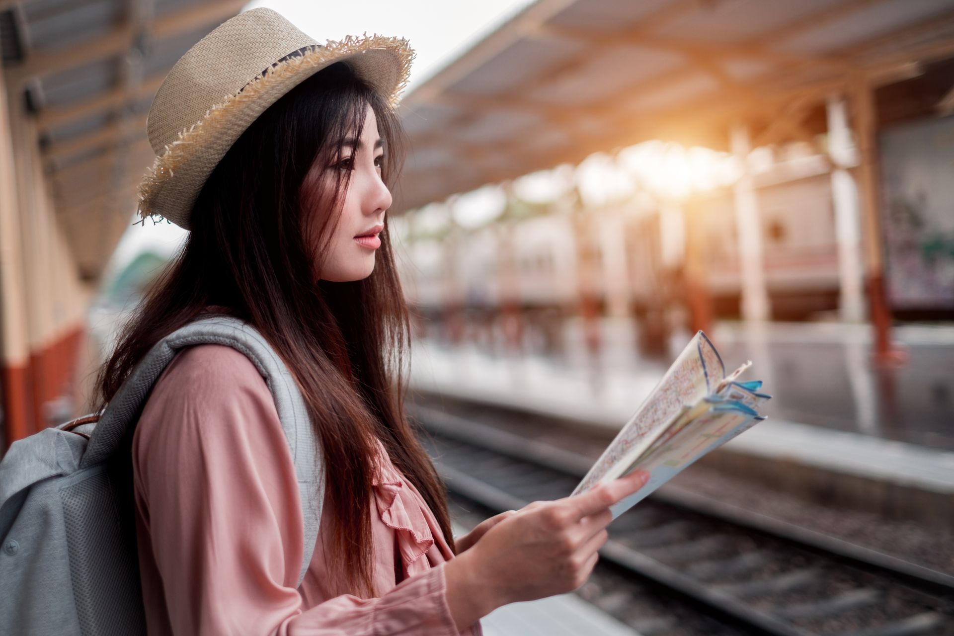 a solo traveller checking a map at a train station a solo traveller checking a map at a train station