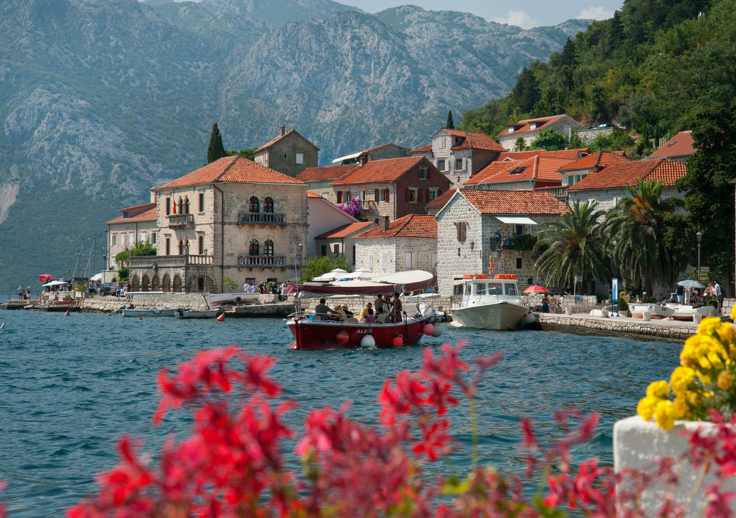 a boat and old town of Perast