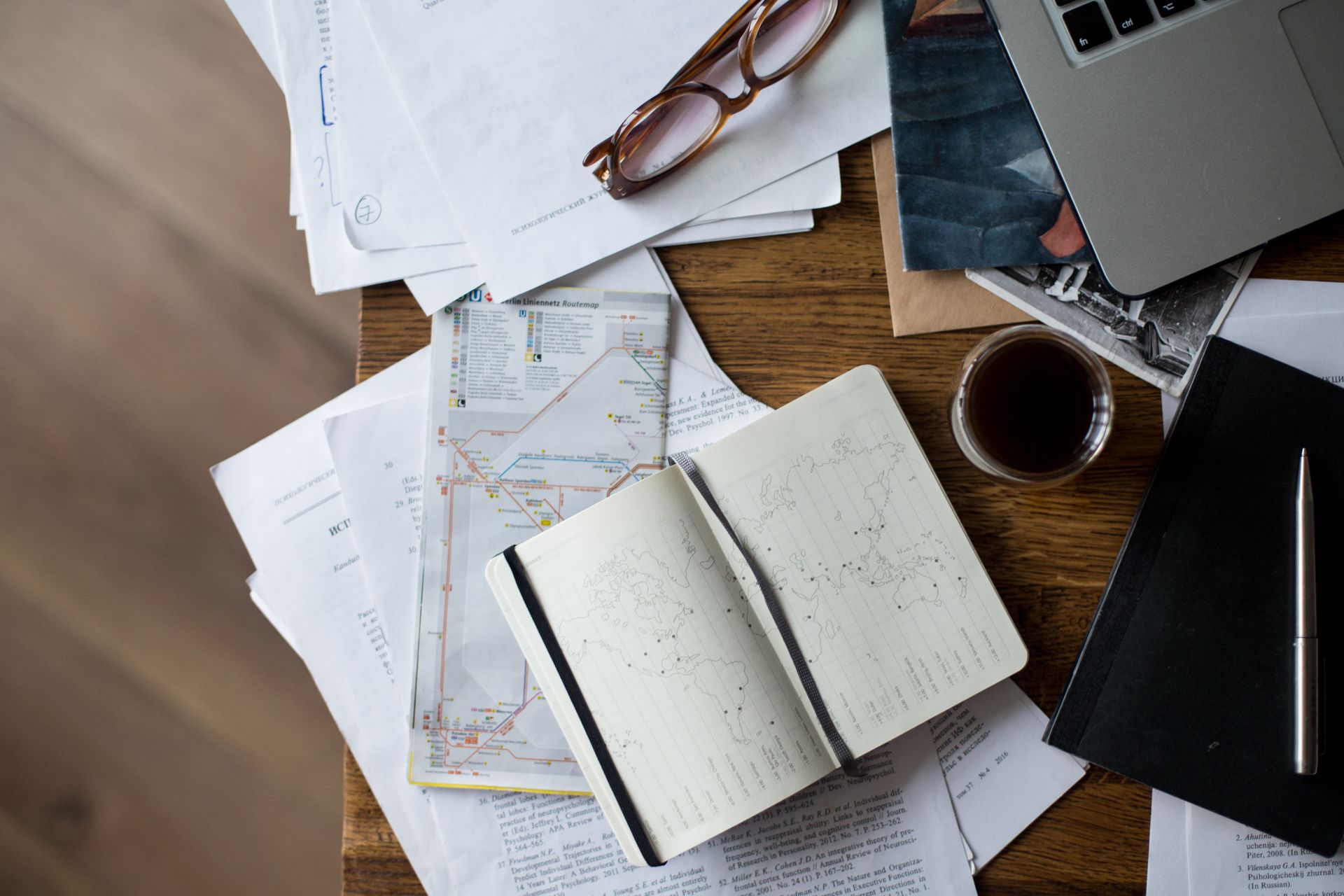 travel planner desk itinerary notes laptop
